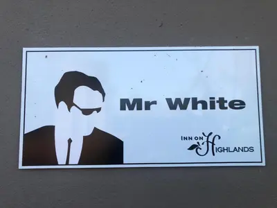 a sign that says mr white on a wall at Inn On Highlands in Grabouw