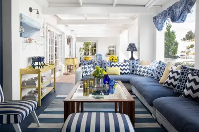 a living room with blue and white couches and a table at Our Hermanus House in Hermanus