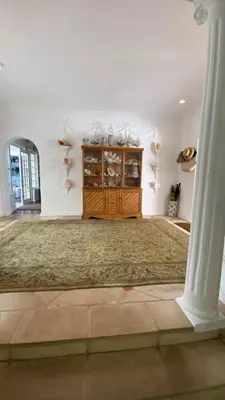 a large living room with a wooden cabinet and a pillar at Our Hermanus House in Hermanus
