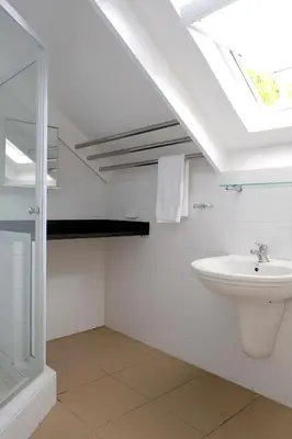 a bathroom with a sink and a skylight at Laurel Cottage in Franschhoek