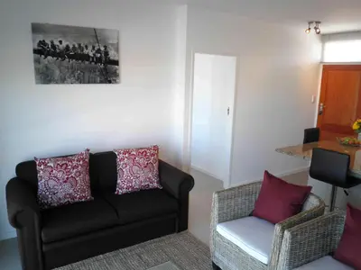 a living room with a couch and a chair at 308 St Tropez in Strand