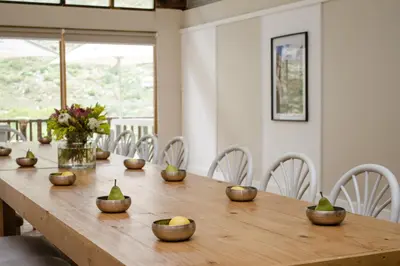 a wooden table with bowls of fruit on it at Du Kloof Lodge in Paarl