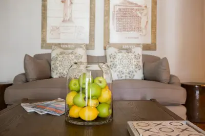 a vase of fruit on a table in a living room at Mont d'Or Franschhoek in Franschhoek
