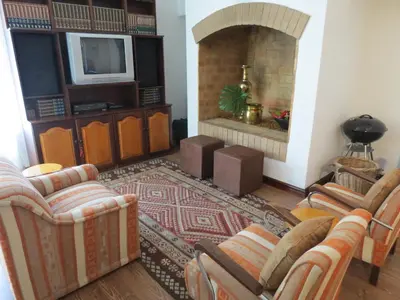 a living room with couches and a fireplace at 10 Kommandeurs Ave, Stellenbosch in Stellenbosch