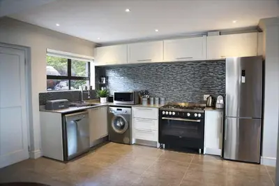 a kitchen with a stove and a dishwasher at Proteus Beach House in Rooiels