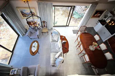 an overhead view of a living room with a couch at Proteus Beach House in Rooiels