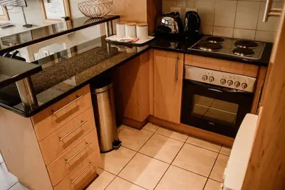 a kitchen with a stove and a counter top at Concord Apartment in Stellenbosch