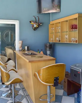 a kitchen with a counter and stools in a room at 1AA Wilhelmina Luxury Suites in Franschhoek