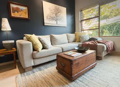 a living room with a couch and a coffee table at Treehouse at Theebos in Strand