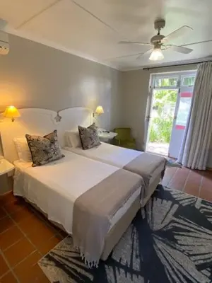 a bedroom with a large white bed with a ceiling fan at The Prime Spot in Worcester