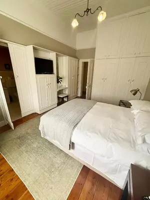 a bedroom with a large white bed and a television at The Prime Spot in Worcester