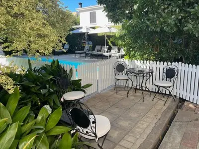 a patio with chairs and tables in front of a fence at The Prime Spot in Worcester