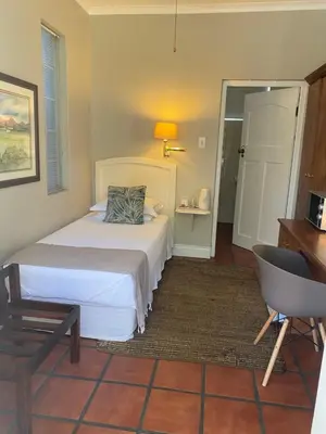 a bedroom with a bed and a desk and a chair at The Prime Spot in Worcester