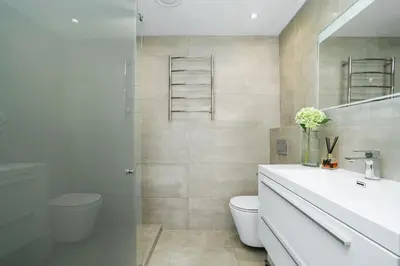 a bathroom with a toilet and a sink and a mirror at Dolphin Beach H106 in Bloubergstrand