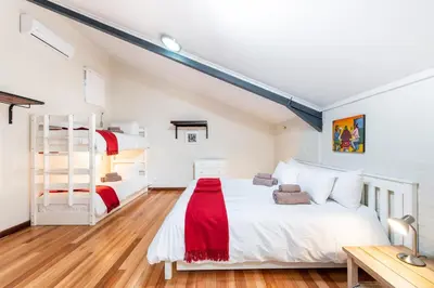 a bedroom with two bunk beds and a ladder at Trail's End in Elgin