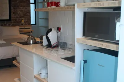 a kitchen with a counter top with a microwave at No. 9 Keurboom in Cape Town