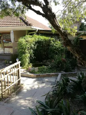 a yard with a fence and a house at Willows Curve in Somerset West