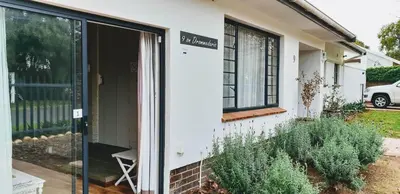 a white house with a sign on the side of it at 9 on Drommedaris in Stellenbosch