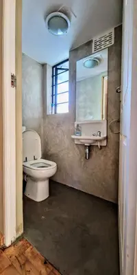 a bathroom with a toilet and a sink and a mirror at 9 on Drommedaris in Stellenbosch