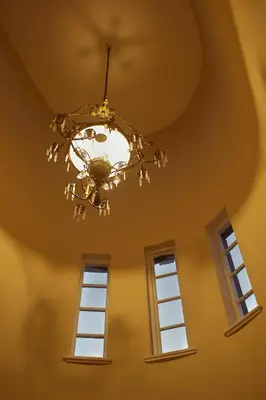a chandelier in a room with two windows at Baruch Guesthouse on Lovell in Stellenbosch