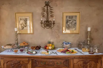 a table with many plates of food on it at Baruch Guesthouse on Lovell in Stellenbosch