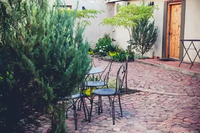 a group of chairs and tables on a brick patio at Station House Simondium in Simondium