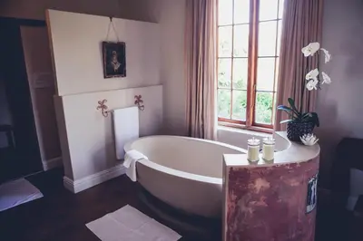 a bath tub in a bathroom with a window at Station House Simondium in Simondium
