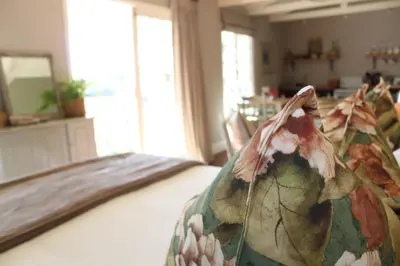 a bedroom with a bed with a blanket on it at Cheverells Farm, Kiku & Braeburn Cottage in Grabouw