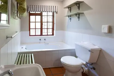 a bathroom with a tub and a toilet and a sink at Summerhill Guest Farm in Worcester