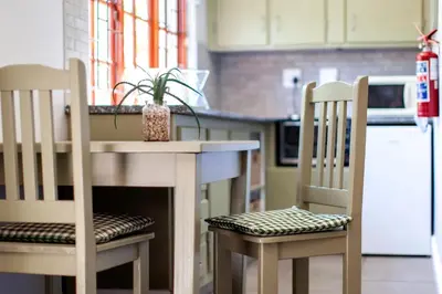 a kitchen with a table and two chairs with a plant on it at Summerhill Guest Farm in Worcester