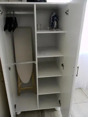 a white bookcase with shelves in a room at Zamar Guest House in Caledon