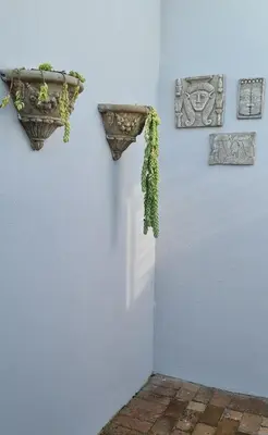 a blue wall with two flower pots on the wall at Mossel 11 Studio in Bloubergstrand