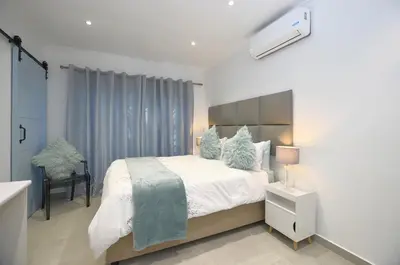 a bedroom with a large bed in a room at Mossel 11 Studio in Bloubergstrand