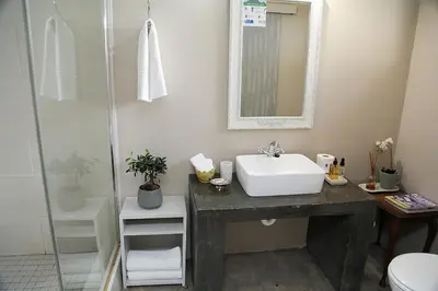 a bathroom with a sink and a shower at 5 Konings Guesthouse in Paarl