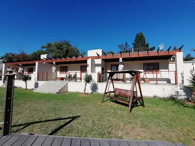 a swing in a yard in front of a house at Lauradale Accommodation in Stellenbosch