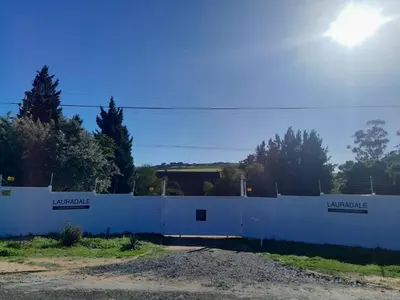 a white fence in front of a building at Lauradale Accommodation in Stellenbosch