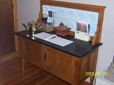 a wooden cabinet with a counter top with a desk at Berg en Dal Guesthouse in Villiersdorp