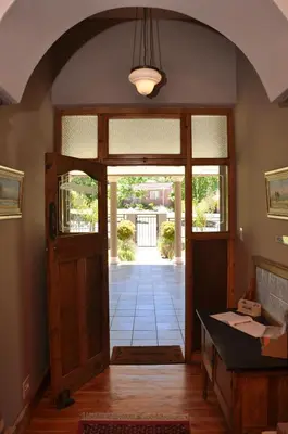 an archway leading to aoyer with a door at Berg en Dal Guesthouse in Villiersdorp