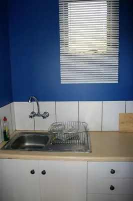 a kitchen counter with a sink and a window at Maleki in Windmeul