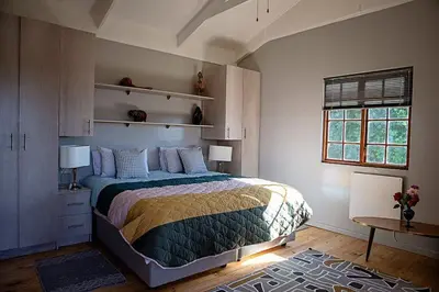 a bedroom with a large bed and a window at Maleki in Windmeul