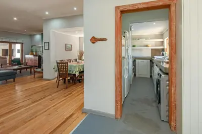 a kitchen and living room with a mirror on the wall at The Koppie - Accommodation in Hermanus