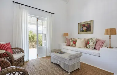 a living room with a couch and a chair at La Cotte Forest Cottages in Franschhoek
