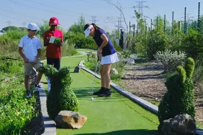 two people playing golf on a golf course at Azura Sleep Brackenfell in Brackenfell