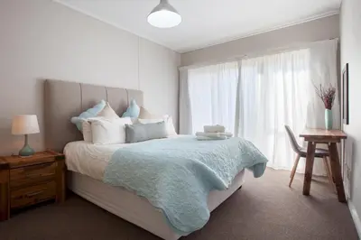 a bedroom with a large bed and a window at Manhattan Towers 507 by CTHA in Cape Town