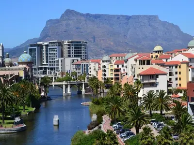 a city with a river and buildings and a mountain at Manhattan Towers 507 by CTHA in Cape Town