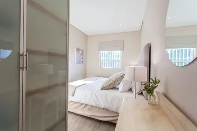 a bedroom with a bed and a glass door at 109 on Dorp in Stellenbosch