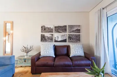 a living room with a brown leather couch at 109 on Dorp in Stellenbosch