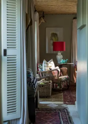 a living room with a chair and a lamp at Vredenhof Farm Cottage in Elgin