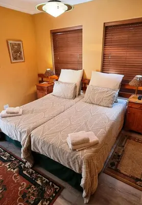 a bedroom with a large bed with two towels on it at Blue Mountain Guest House in Bloubergstrand