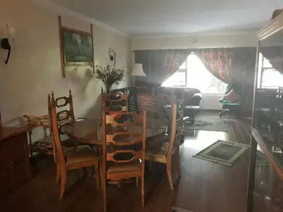 a dining room with a table and chairs at Overmeer in Worcester